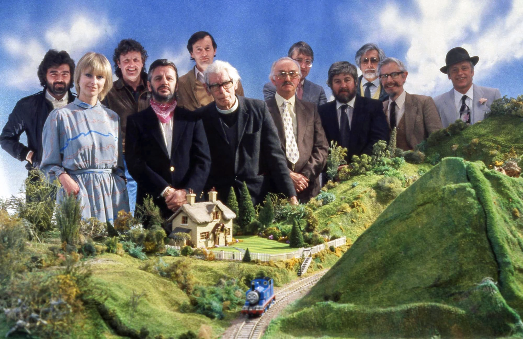 Crew van de eerste Thomas-serie bij een miniatuurmodel van Sodor